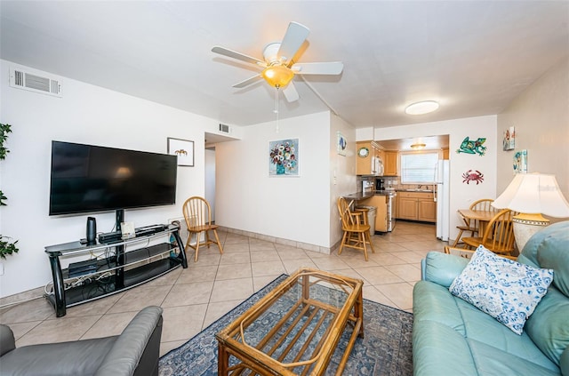 tiled living room featuring ceiling fan