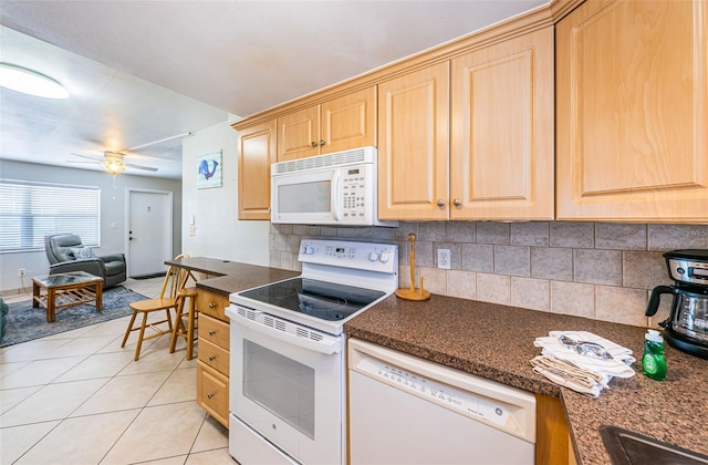 kitchen with white appliances, ceiling fan, light tile floors, dark stone countertops, and tasteful backsplash