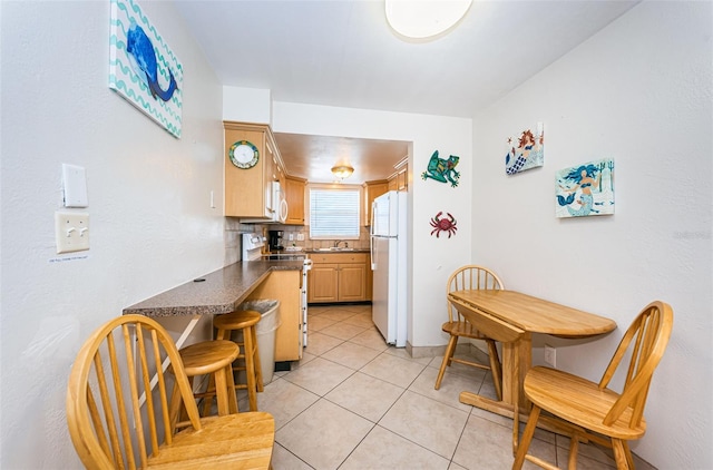 kitchen with light tile floors, tasteful backsplash, and white appliances