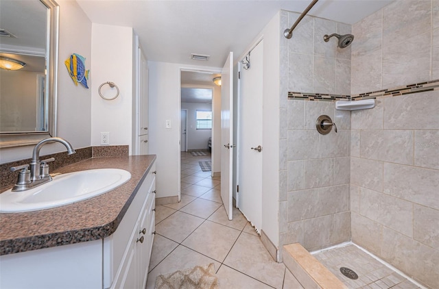 bathroom with tile flooring, oversized vanity, and tiled shower