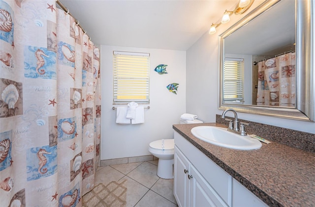 bathroom with tile flooring, large vanity, toilet, and a wealth of natural light