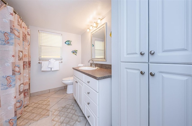 bathroom with oversized vanity, toilet, and tile floors