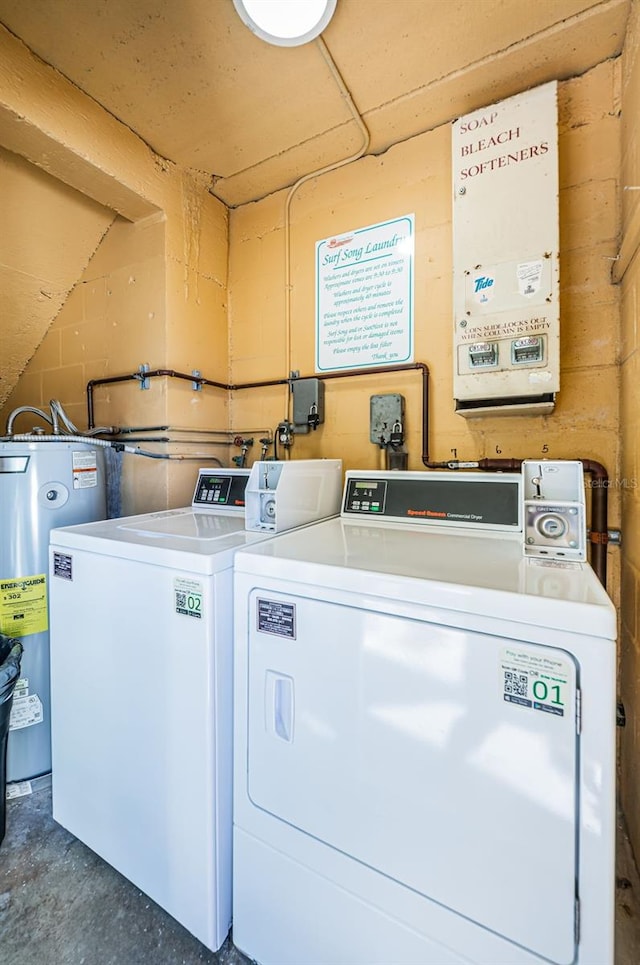 laundry room featuring water heater and separate washer and dryer