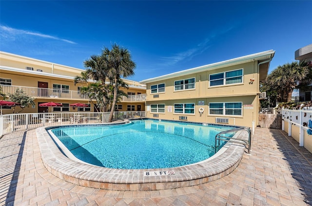 view of swimming pool with a patio area