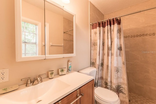 bathroom with vanity, toilet, and walk in shower