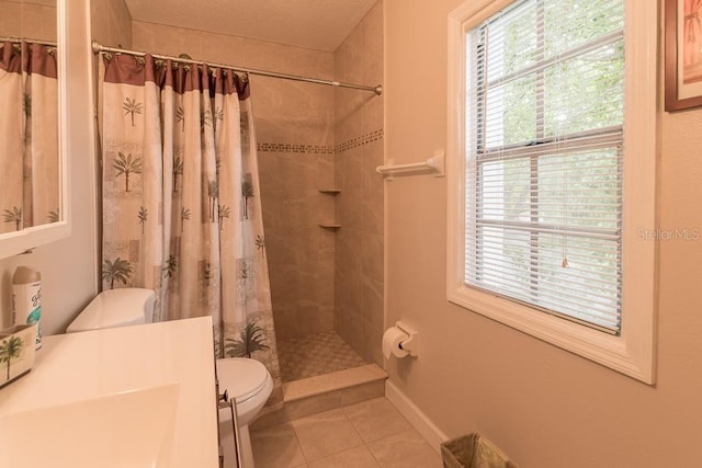 bathroom featuring tile patterned floors, toilet, and curtained shower