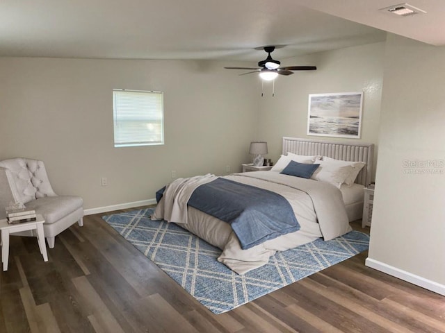 bedroom with ceiling fan and dark hardwood / wood-style floors