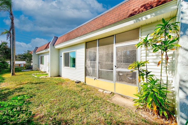 view of side of property with a lawn