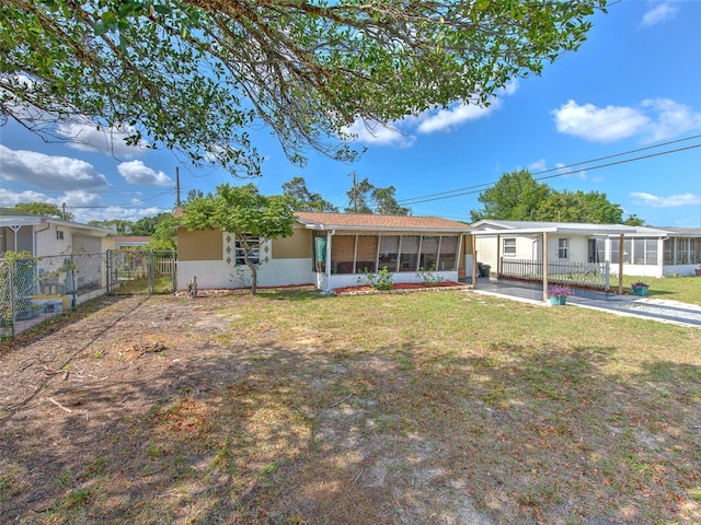 view of front of home featuring a front yard and a sunroom