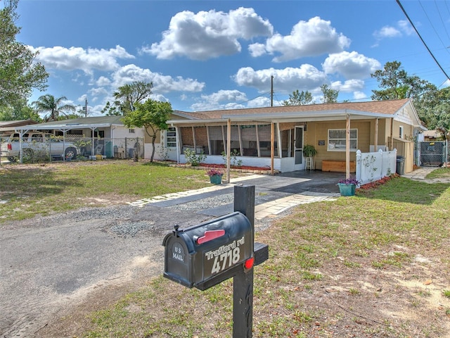 single story home featuring a carport and a front lawn