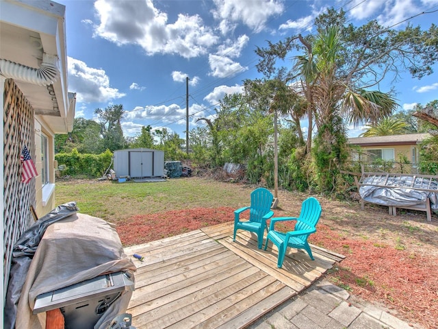 deck with a grill, a lawn, and a shed