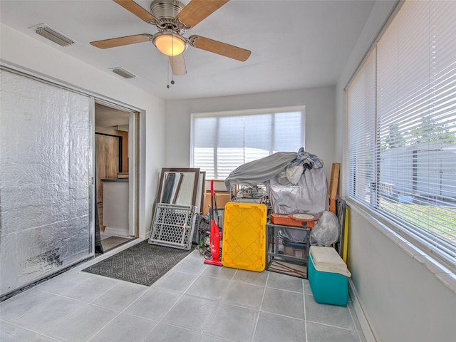 recreation room featuring light tile floors and ceiling fan