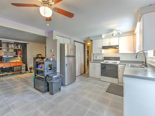 kitchen featuring ceiling fan, sink, white electric range oven, white cabinets, and stainless steel refrigerator