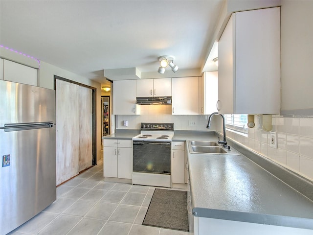 kitchen with sink, white electric stove, white cabinets, stainless steel refrigerator, and tasteful backsplash