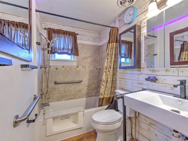 bathroom with toilet and shower / tub combo with curtain