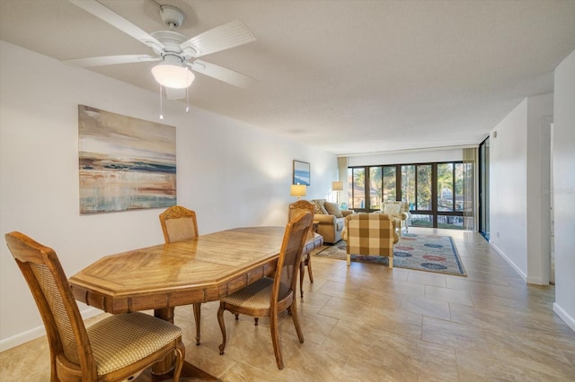 dining room with ceiling fan and light tile flooring