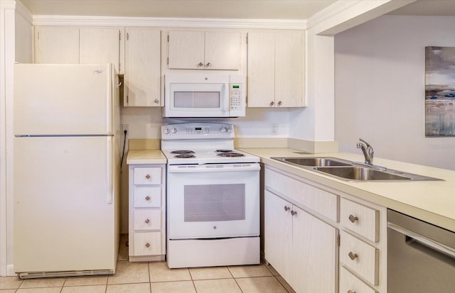 kitchen with light tile floors, white appliances, and sink