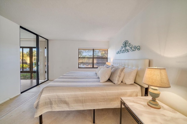 bedroom featuring light carpet, floor to ceiling windows, a textured ceiling, and access to exterior