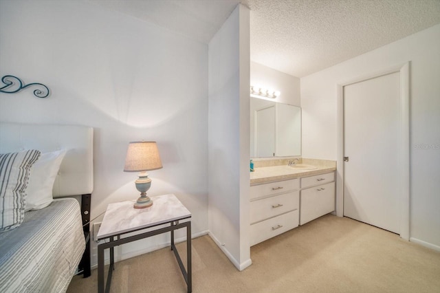 bathroom with vanity and a textured ceiling