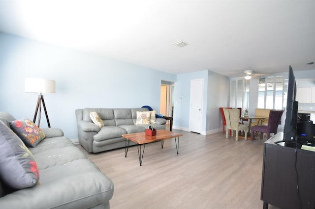 living room featuring ceiling fan and light wood-type flooring