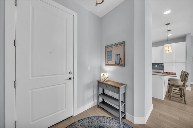 entrance foyer featuring sink and light hardwood / wood-style flooring