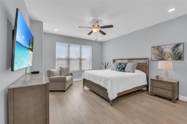 bedroom with light hardwood / wood-style floors and ceiling fan