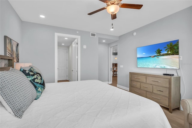 bedroom with ceiling fan and light hardwood / wood-style flooring