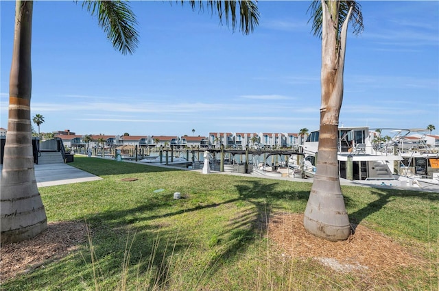 view of dock featuring a water view and a lawn