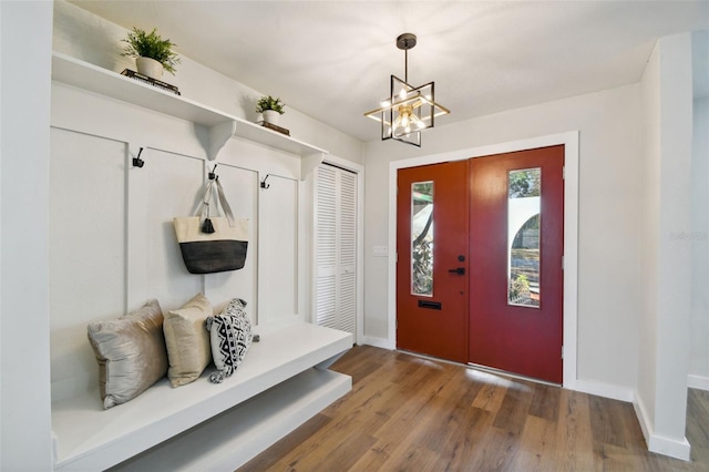 mudroom featuring hardwood / wood-style floors and an inviting chandelier