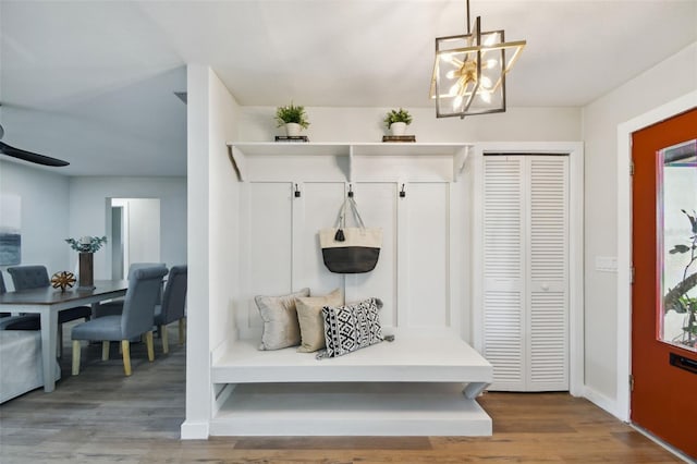 mudroom featuring wood-type flooring and a notable chandelier