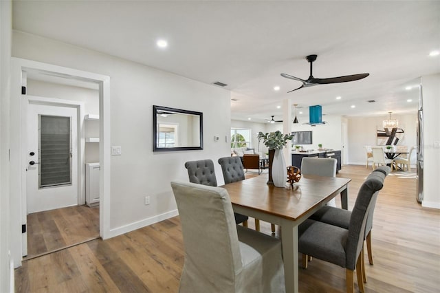 dining area with light hardwood / wood-style flooring and ceiling fan