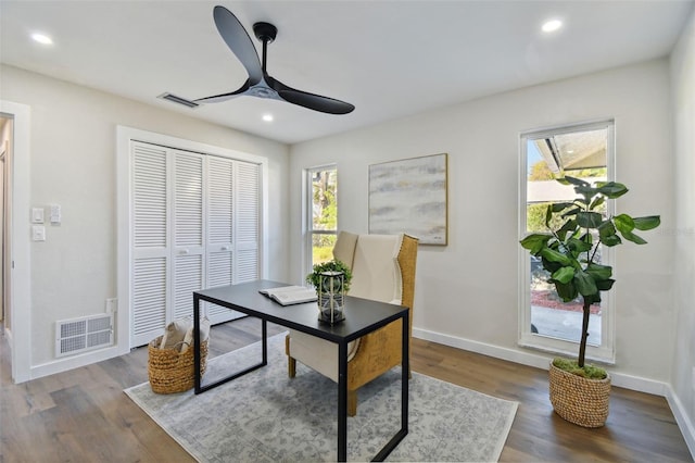 office area with plenty of natural light, dark hardwood / wood-style floors, and ceiling fan