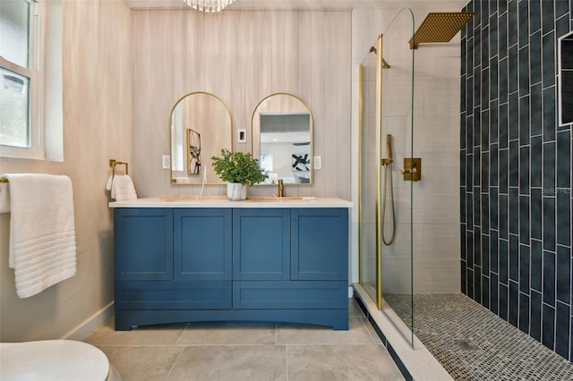 bathroom featuring a tile shower, tile patterned floors, and vanity