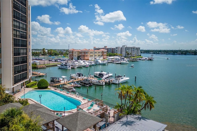 view of pool with a boat dock and a water view