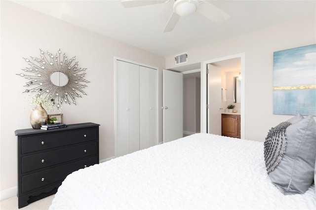 carpeted bedroom featuring a closet, connected bathroom, and ceiling fan