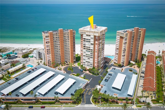 drone / aerial view featuring a water view and a beach view