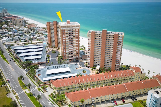 drone / aerial view featuring a water view and a view of the beach