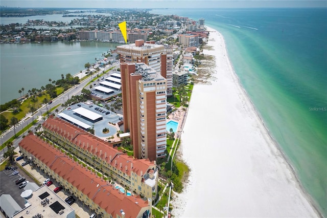 bird's eye view with a water view and a beach view