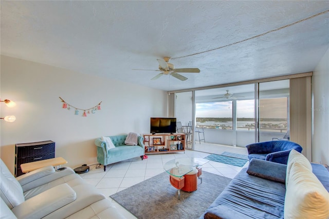 tiled living room with ceiling fan