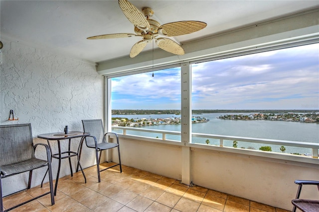 interior space featuring a water view and ceiling fan