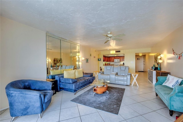 tiled living room with ceiling fan and a textured ceiling