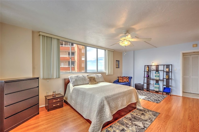 bedroom with ceiling fan and light hardwood / wood-style flooring