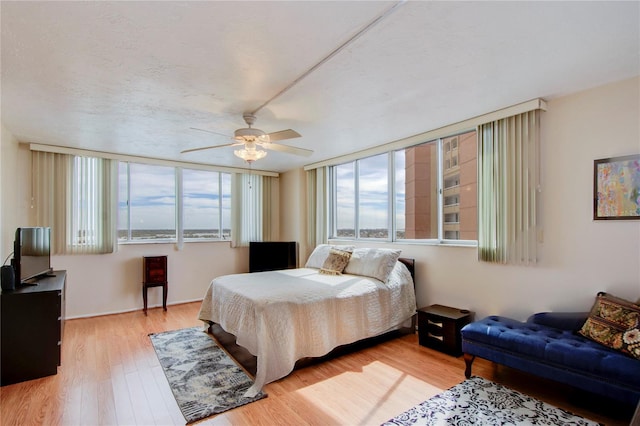 bedroom with ceiling fan and light hardwood / wood-style flooring