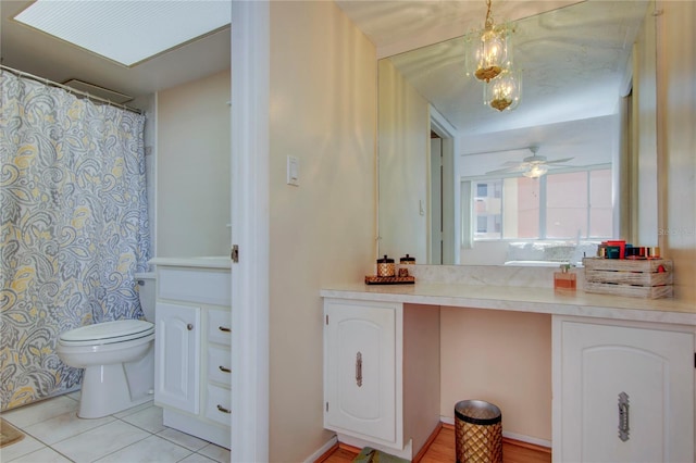 bathroom featuring vanity, tile flooring, ceiling fan, and toilet