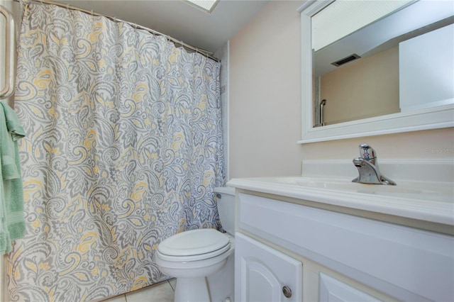 bathroom featuring toilet, large vanity, and tile flooring