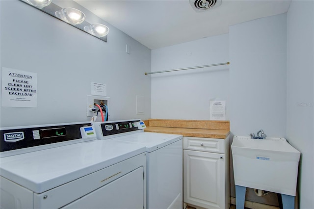 laundry area with washer and dryer and sink