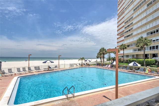 view of swimming pool with a water view