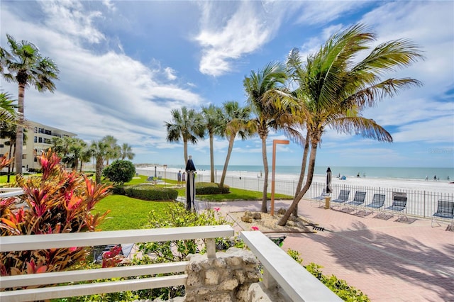 view of yard featuring a water view and a view of the beach