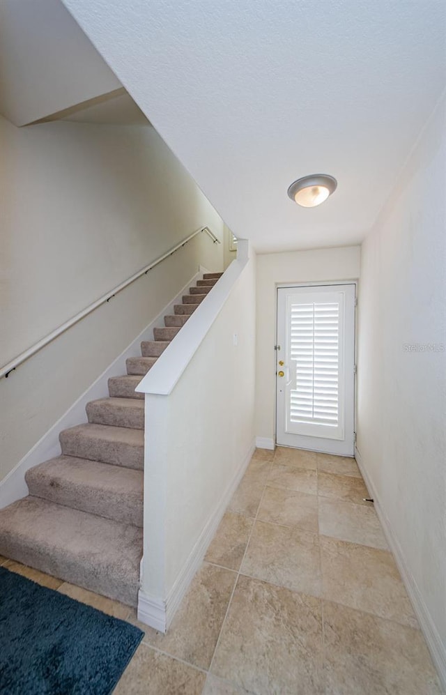 stairs with light tile floors