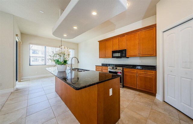 kitchen featuring stainless steel electric range, light tile floors, sink, a kitchen island with sink, and a chandelier